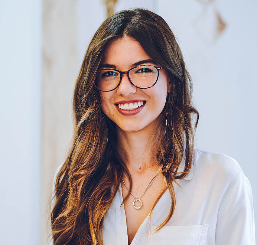 Custom mouthguard options for dental protection and comfort, featuring a smiling woman wearing glasses, emphasizing oral health and personalized care at Biodental Health and Longevity.
