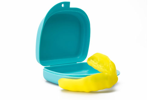 Mouthguard in a turquoise case, emphasizing dental protection for sports and fresh breath care.