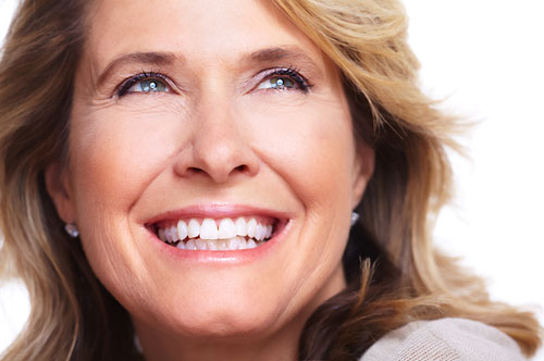 Smiling woman with healthy, bright teeth and fresh breath, embodying confidence and dental care.