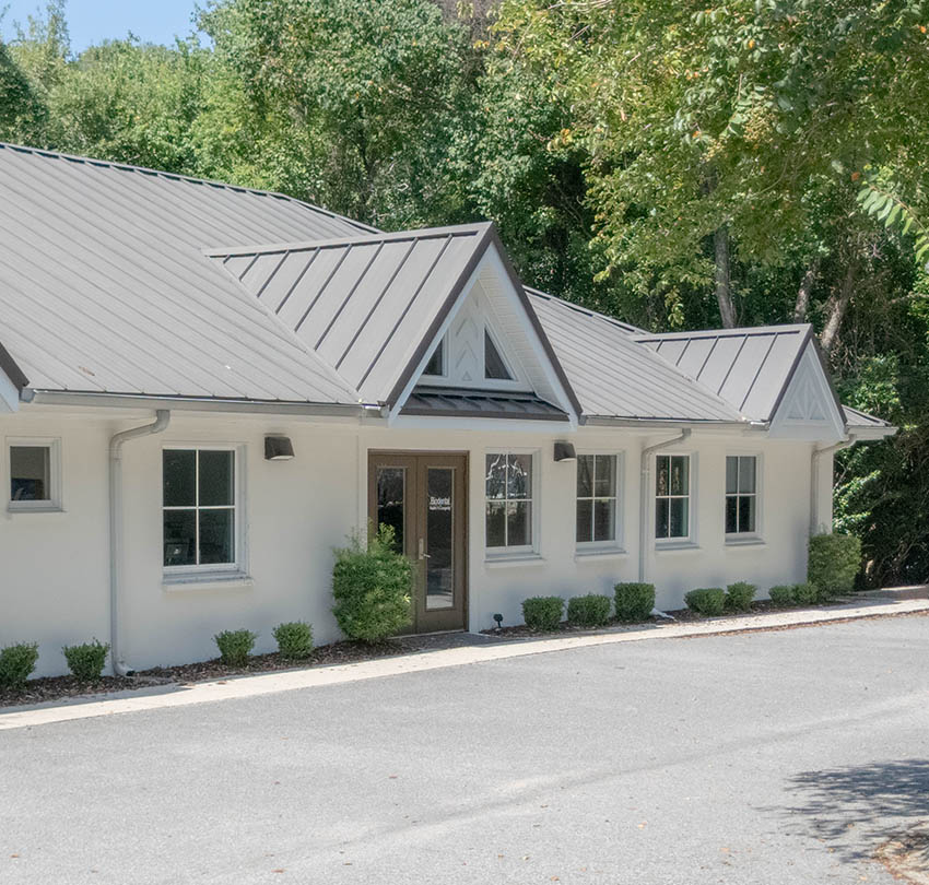 Biodental Health and Longevity office building with modern architecture, surrounded by greenery, emphasizing a welcoming environment for sleep apnea treatments.